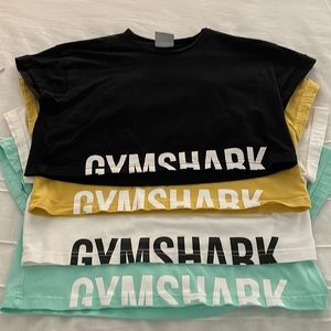 4 gym shark cropped tees, all xs, black, yellow, white, and mint green
